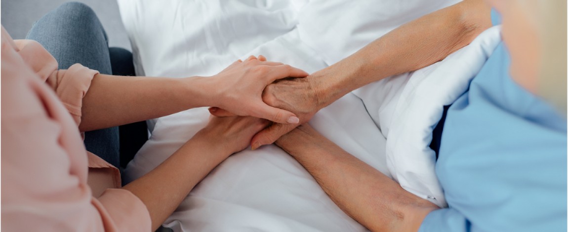 Family members holding patient’s hand