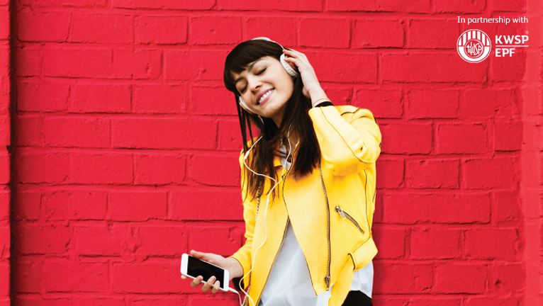 Young lady happily listening to music on her mobile device