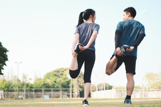 Couple stretching in the park