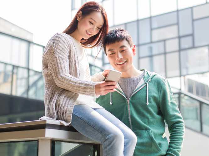 Couple receive payment on phone