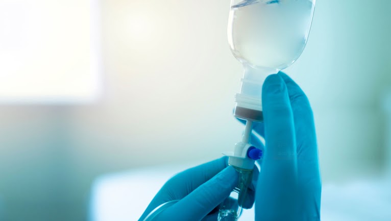 Doctor adjusting IV drip