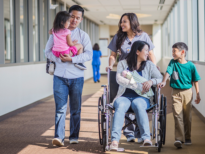 Girl on wheelchair with family