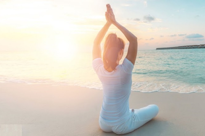 Girl yoga on the beach