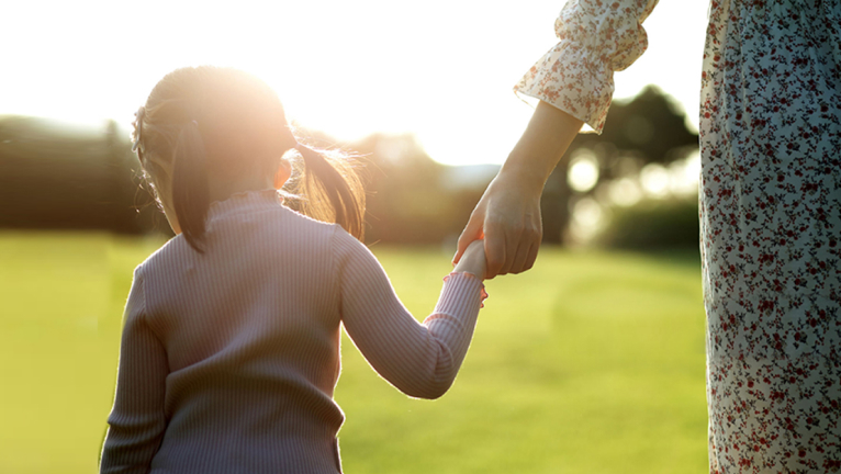 Mother and daughter holding hands