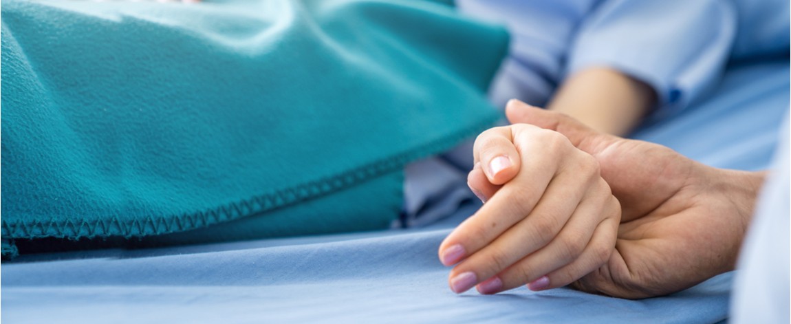 Cancer patient in hospital bed