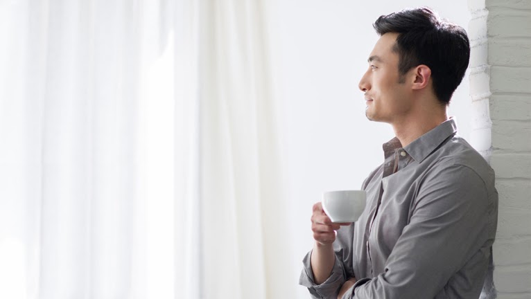 Young man gazing out the window